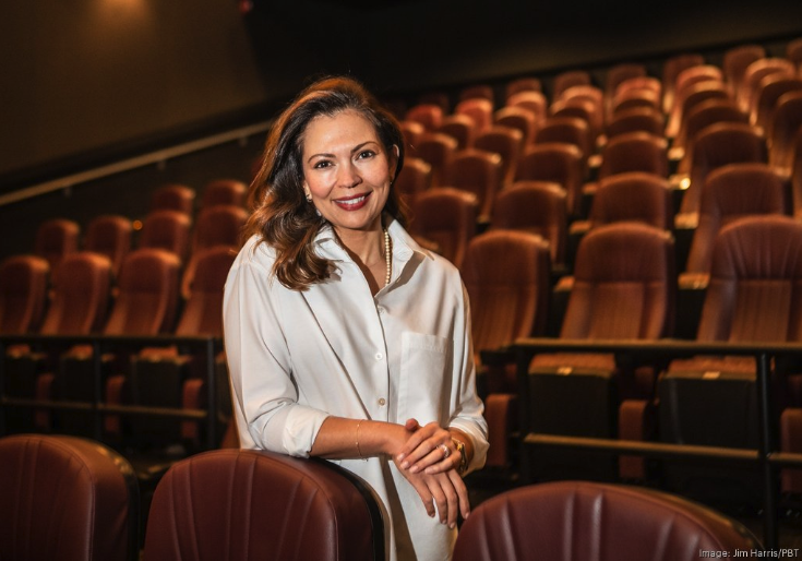 Carolina Thor CEO stands in darkened movie theater.