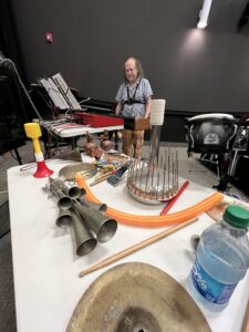 A table with multiple instruments, horns, and tubes