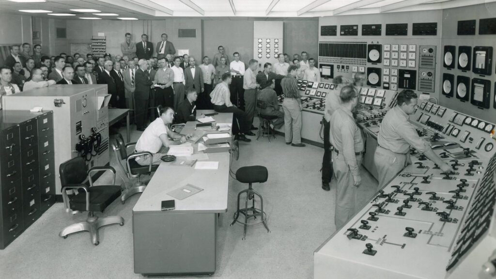 Large group sitting in control room